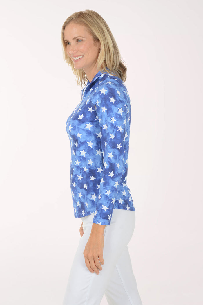 Woman wearing a blue star-patterned shirt on a white background