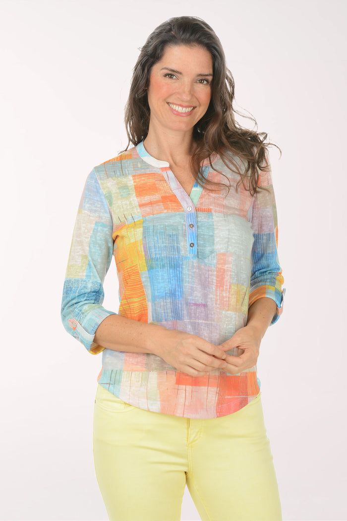 A woman wearing a multicolored plaid 3/4 sleeve top.